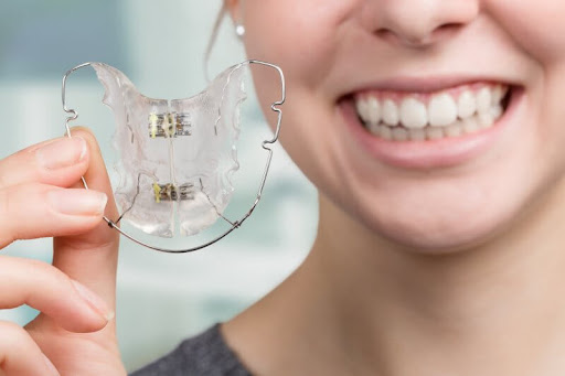 Smiling Holding Retainer